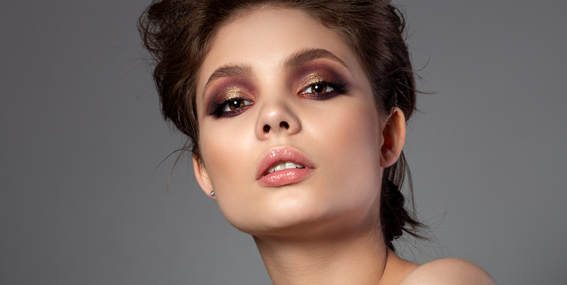 Woman with a stunning rose gold metallic smoky eye makeup look